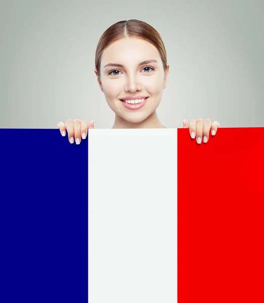 Happy woman showing French flag background. Travel in France — Stock Photo, Image