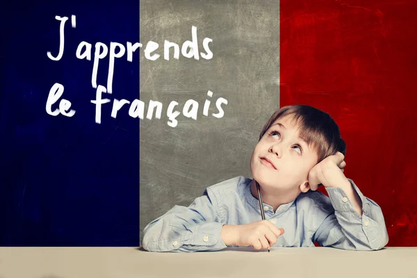 Learn french language concept. Happy child student and tittle
