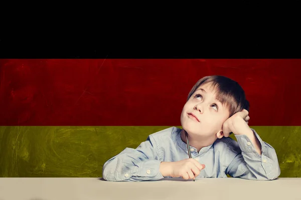 Myślenie dziecko chłopiec student przeciwko Niemcy flaga tle. — Zdjęcie stockowe