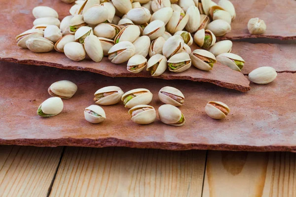 Tasty Raw pistachio nut on tree rind background — Stock Photo, Image