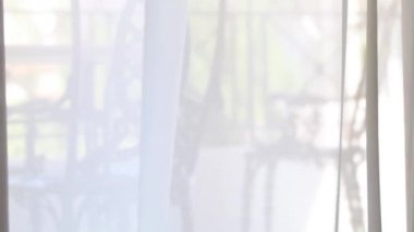 Pencerede rüzgarda dalgalanan perdeler. Pencerede rüzgar var. Pencereyi teraslı aç