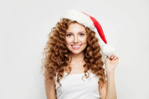 Happy Christmas woman in Santa hat smiling on white background. — Stock Photo, Image