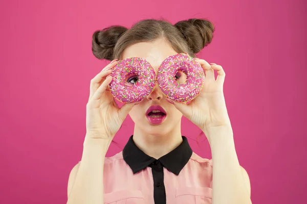 Όμορφη Γυναίκα Ψάχνει Μέσα Από Ντόνατς Έντονο Ροζ Φόντο Δίαιτα — Φωτογραφία Αρχείου