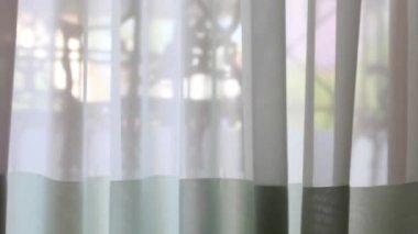 Rüzgâr beyaz perdeyi savuruyor balkonun yanında