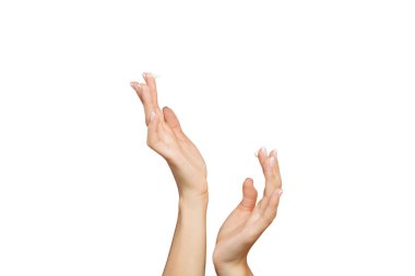 Two beautiful female hand with cosmetic moisturiser on her finger isolated on white background