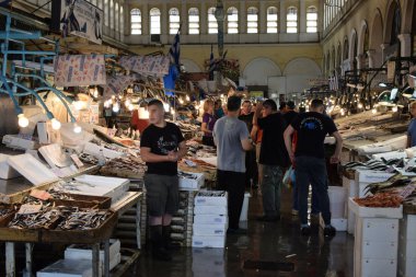 ATHENS, GREECE - JULY 19, 2018: People shopping at the central municipal meat and fish market. Traditional marketplace in downtown Athens. clipart