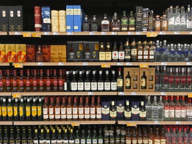 Athens, Greece - November 14, 2019: Whisky and vodka alcoholic drink beverage bottles on display at liquor store.