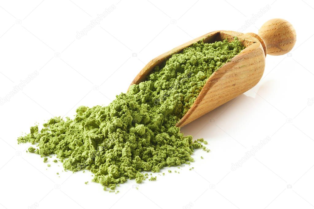 Scoop of green matcha tea powder isolated on white background