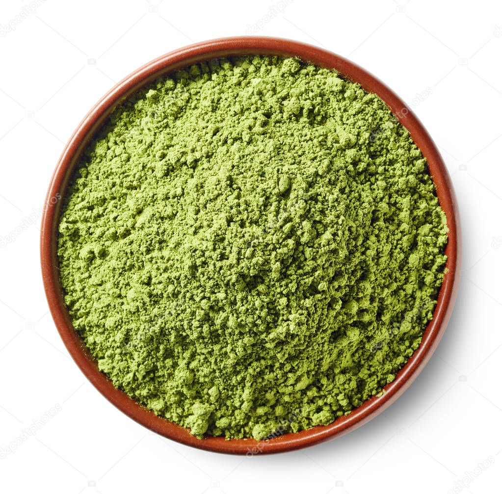 Brown bowl of green matcha tea powder isolated on white background. Top view