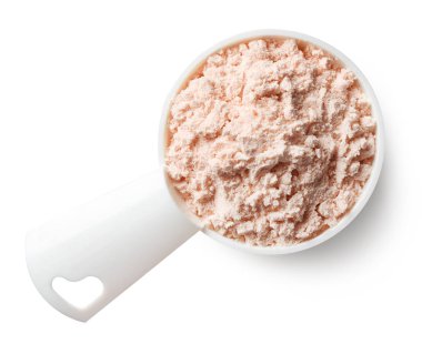 Plastik kaşık beyaz arka plan üzerinde izole pembe çilek protein tozu ölçme. Üstten görünüm