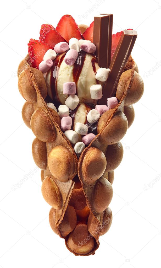 Hong kong or bubble waffle with ice cream, chocolate, marshmallows and strawberries isolated on white background