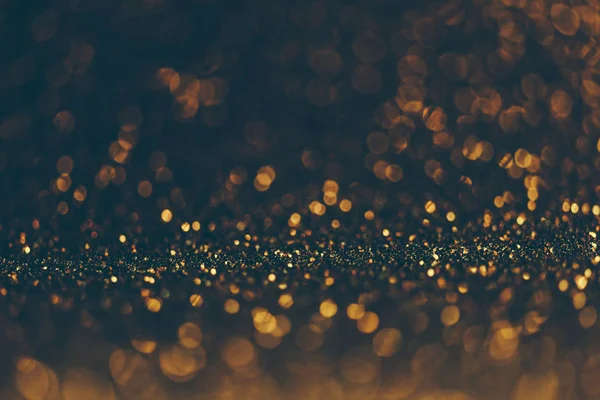 Blur neon gold and blue light circle background. Sparkling firework bokeh dots in vintage style. Luxury and classy new year and christmas celebration party textured dark backdrop. Blurry golden dust.