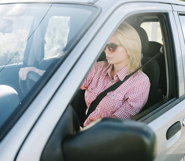 Νεαρή ξανθιά γυναίκα οδήγηση αυτοκινήτου. — Φωτογραφία Αρχείου