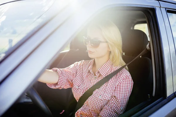 Happy young woman driver driving her new luxury car. — Stock Photo, Image