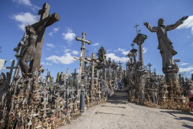SIAULIAI, LITHUANIA - AUGUST 15, 2018 - Hill of Crosses is a famous pilgrimage place in Lithuania. clipart