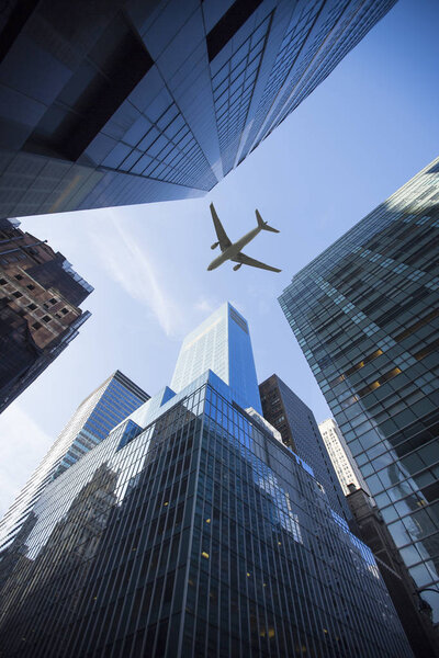 The plane flies over the city over New York
