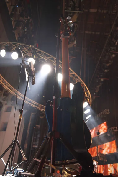 guitar at a concert on stage in the rays of light.