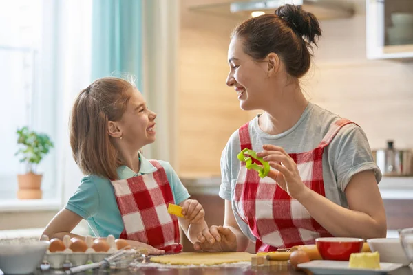 快乐的 充满爱心的家庭正在一起准备烘焙 母女俩的女儿在厨房里做饼干 玩得很开心 家庭自制食品和小帮手 — 图库照片
