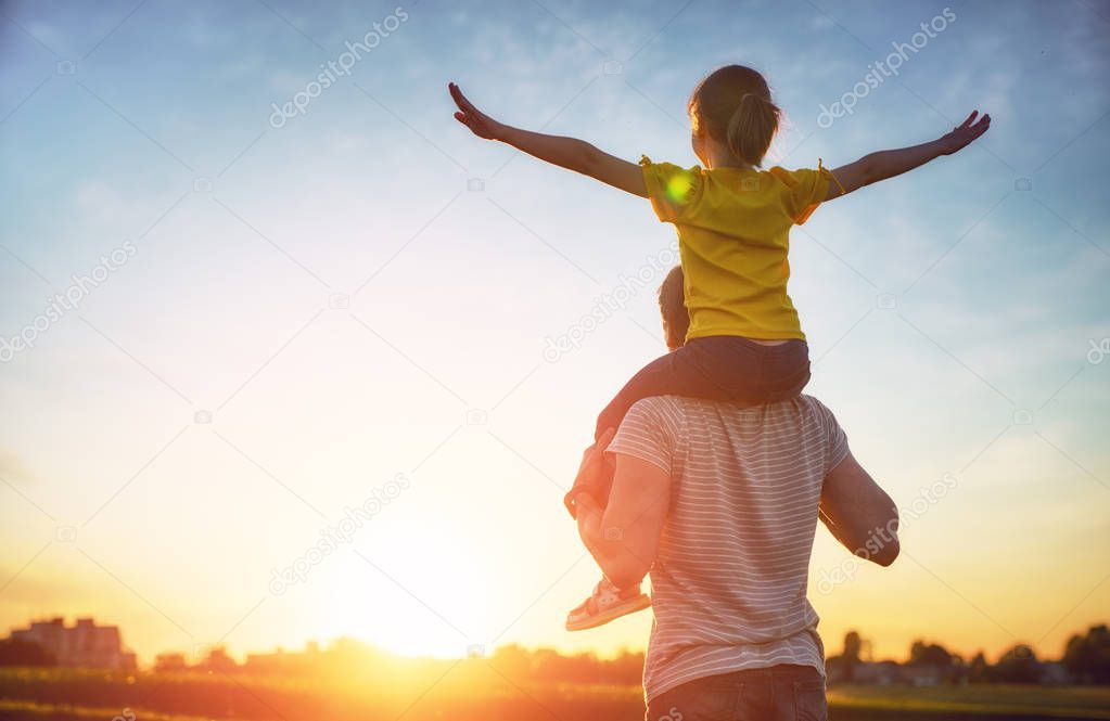 Happy loving family. Father and his daughter child playing and hugging outdoors. Cute little girl and daddy. 