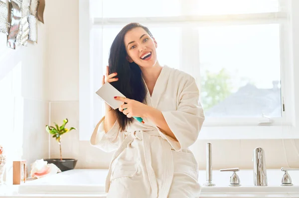 Happy Young Woman Combing Hair Bathroom — Stock Photo, Image