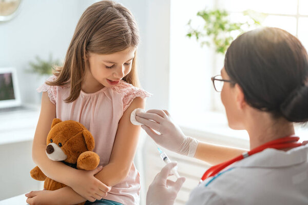 A doctor making a vaccination to a child