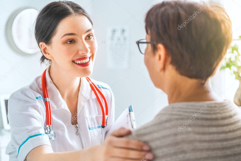 Female patient listening to doctor in medical office.