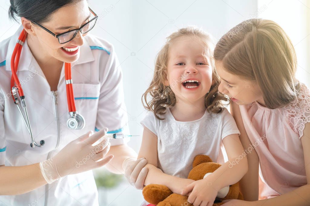 A doctor making a vaccination to a child