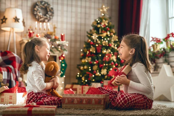 Дівчата відкривають різдвяні подарунки — стокове фото