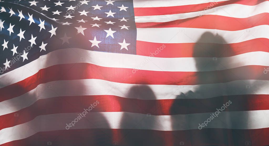 People holding the Flag of the USA.