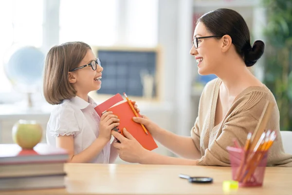 Girl with teacher in classroom. — Stock Photo, Image
