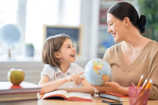 Girl with teacher in classroom. Stock Image