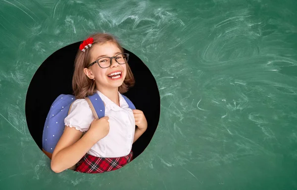 Kid in class on background of chalkboard. — Stock Photo, Image