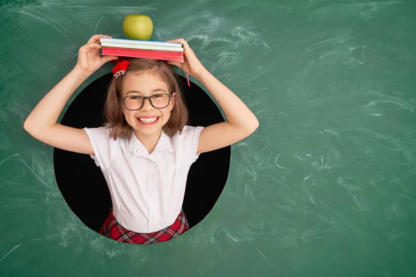 Kid in class on background of chalkboard. — Stock Photo, Image