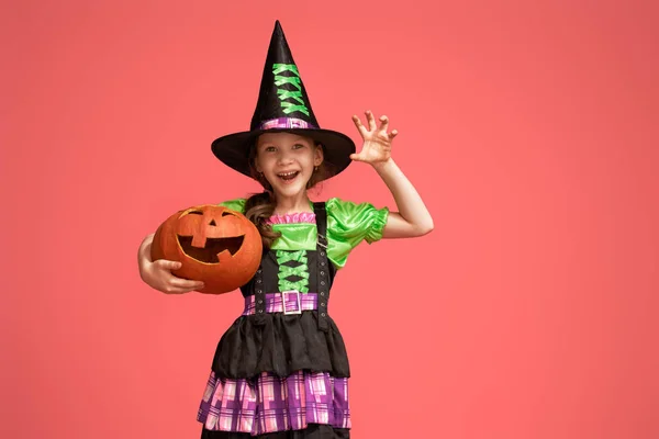 Little witch with a pumpkin on pink background — Stock Photo, Image