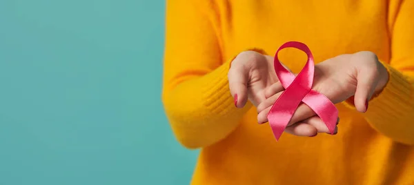 Frauenhände und Symbol des Brustkrebsbewusstseins — Stockfoto