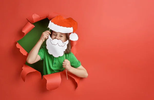 Girl in Santa hat on color background — Stockfoto