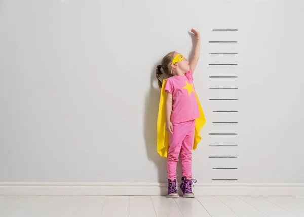 Little Child Playing Superhero Kid Measuring Growth Background Wall Girl — Stock Photo, Image