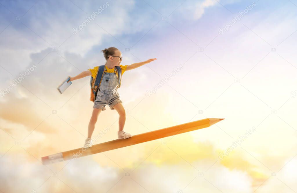 Back to school! Happy cute industrious child flying on the pencil on background of sunset sky. Concept of education and reading. The development of the imagination.