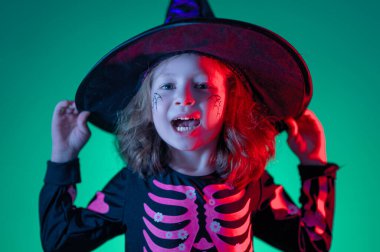 Mutlu Cadılar Bayramı! Renkli ışıkta partideki sevimli küçük cadı..