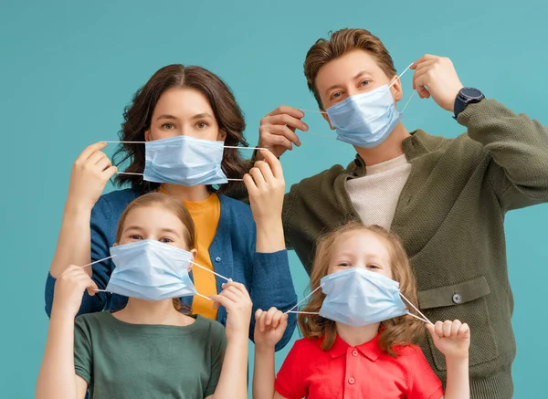 Family is wearing facemasks during coronavirus and flu outbreak. Virus and illness protection, quarantine. COVID-2019. Take on or take off masks.