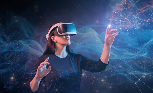 Metaverse technology concept. Woman with VR virtual reality goggles. Futuristic lifestyle.