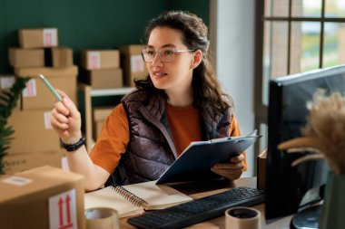 Kadın envanter müdürü stokları kontrol ediyor. Depoda çalışan bir kadın.. 