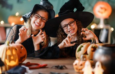 Cadı kostümlü iki kız Cadılar Bayramı 'nı kutluyor. Balkabaklı çocuklar