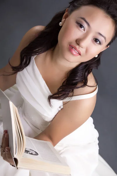 Asian Girl White Dress Reads Book Stock Photo