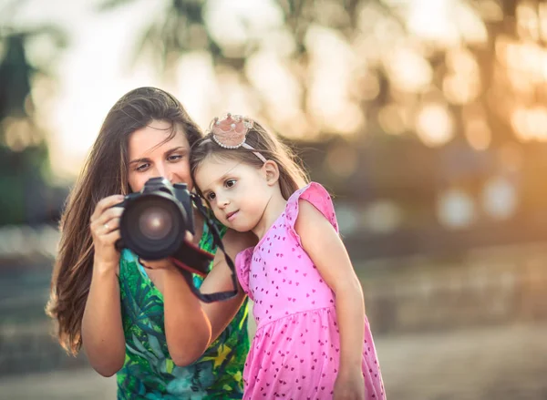 Mother and daughter taking photos with camera — Stock Photo, Image