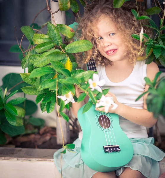 Portrait of a cute girl with ukulele — Stock Photo, Image