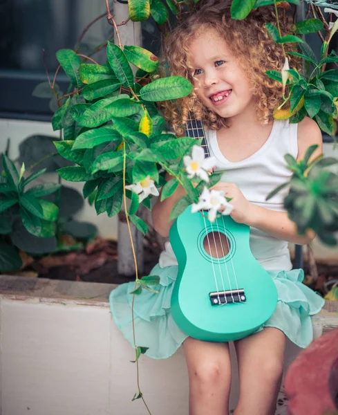 Portrait of a cute girl with ukulele — Stock Photo, Image