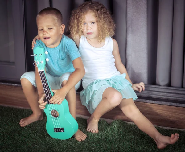 Portrait of a cute kids with ukulele — Stock Photo, Image