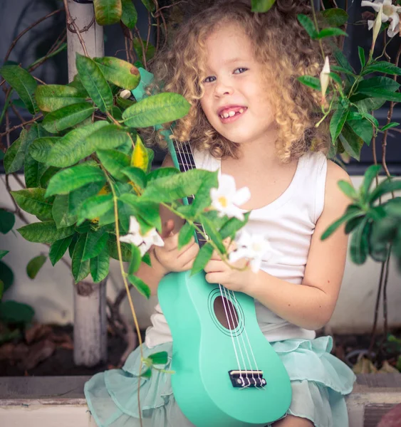 Portrait of a cute girl with ukulele — Stock Photo, Image