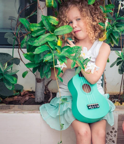 Portrait of a cute girl with ukulele — Stock Photo, Image